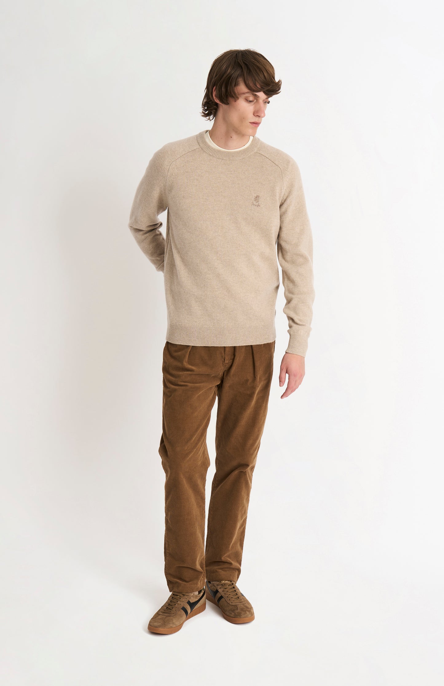 Pringle of Scotland Men’s Lambswool Crew Neck Jumper In Oatmeal on standing model from behind