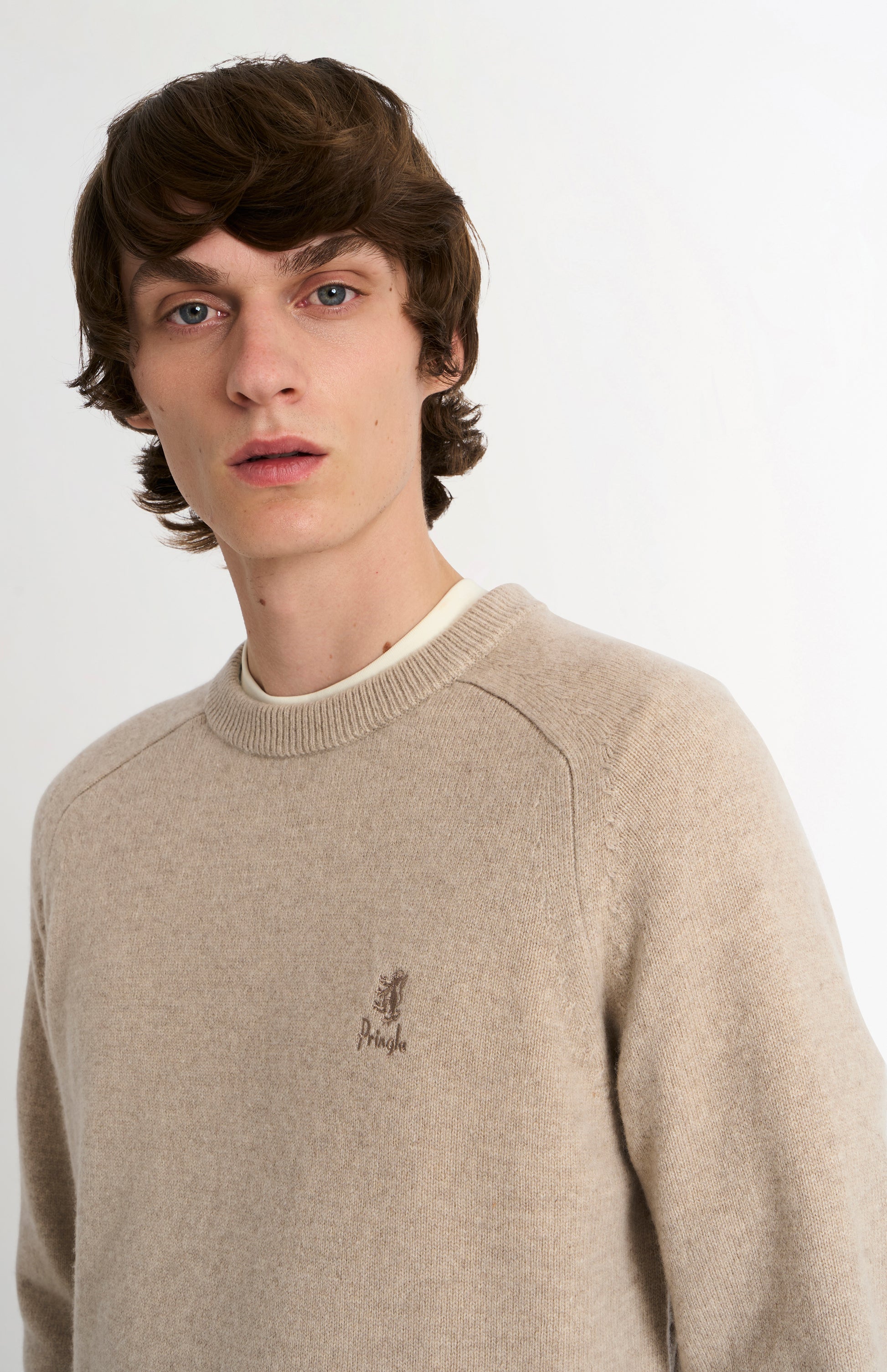 Pringle of Scotland Men’s Lambswool Crew Neck Jumper In Oatmeal sshowing logo embroidery