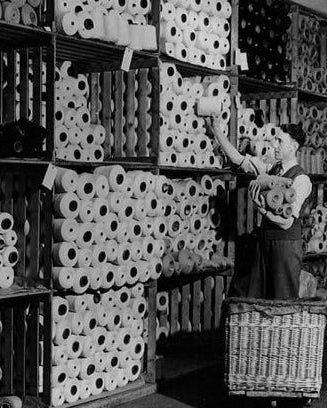 Person working with yarn in a storage room at the Pringle of Scotland factory