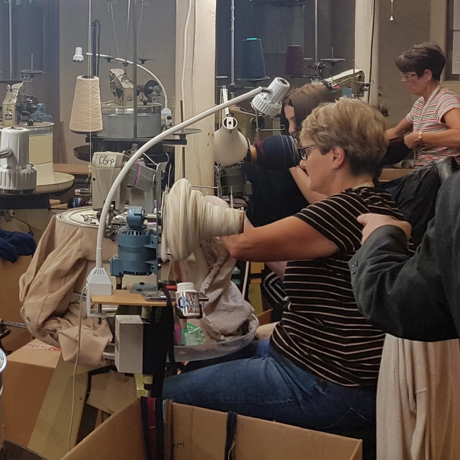 Pringtle of Scotland worker operating linking machine joining necks to bodies of jumpers