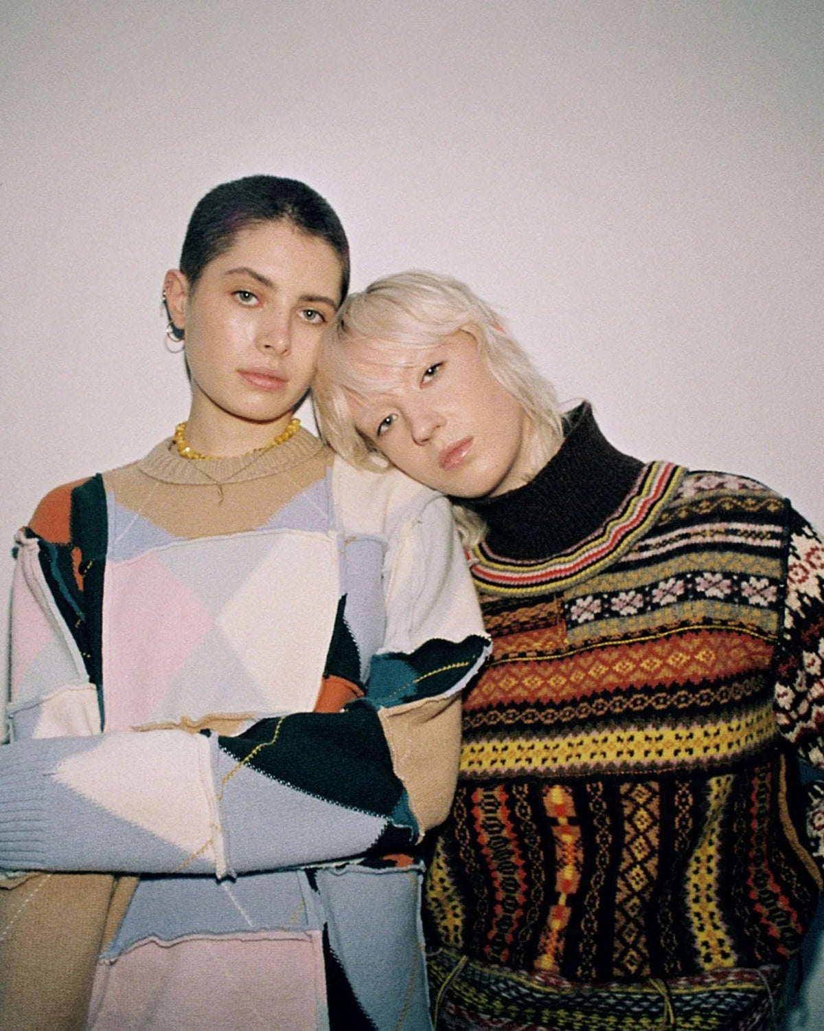 Two individuals wearing colorful patterned sweaters against a plain background, Pringle of Scotland x LN-CC